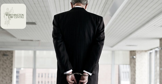 businessman in suit with handcuffs
