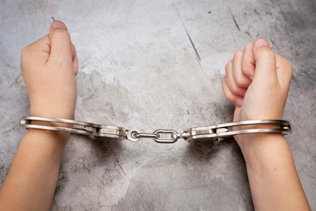 teenager in handcuffs